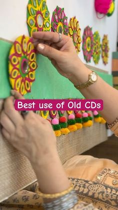 the woman is working on an art project with colorful paper flowers and words that read best use of old cds