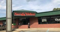 a building with a sign that says family video on the front and side of it