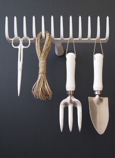 there are four different types of kitchen utensils hanging on the wall with cords