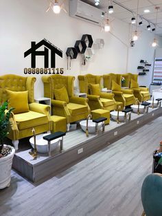 a salon with yellow chairs and mirrors on the wall