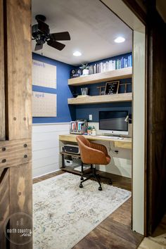 a home office with blue walls and wooden shelves, along with a white rug on the floor