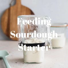 a blender filled with sourdough sitting on top of a counter next to a spoon