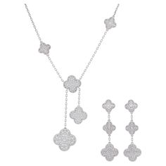 Van Cleef & Arpels Diamond Magic Alhambra Necklace And Earrings Set Crafted In 18k White Gold. Necklace features six Alhambra motifs of various sizes (3x15mm, 2x20.5mm & 1x26mm), encrusted with total of 182 of round brilliant cut diamonds with weight of approximately 6.20ct, .Equipped with lobster claps. Inscribed: VCA, Au750, JExxxxx. Stamped with French hallmark. Length around the neck: 16.5 inches, with jump ring at 15 inches. Length of the drop: 3 inches. Van Cleef & Arpels Magic Alhambra pendant earrings feature six Alhambra motifs, 4 smaller (15mm) and 2 larger20mm), encrusted with total of 158 round brilliant cut diamonds with weight of approx. 4.25ct, Equipped with French clip and removable posts. Inscribed: VCA, Au750, JExxxxx, OR. Stamped with French hallmarks and makers marks. L Van Cleef And Arpels Jewelry Set, Magic Alhambra Necklace, Van Cleef Arpels Diamond, Van Cleef Necklace, Alhambra Necklace, Alhambra Pendant, Van Cleef And Arpels Jewelry, Van Cleef & Arpels, French Clip