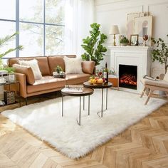 a living room filled with furniture and a fire place in the middle of a room