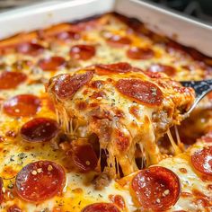 a slice of pepperoni pizza being lifted from a casserole dish