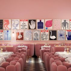 the interior of a restaurant with pink walls and tables covered in white tablecloths