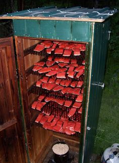 an outhouse filled with lots of red items in the yard at night or day