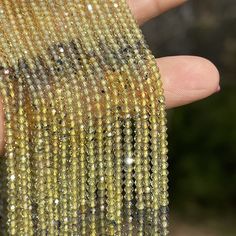 a hand is holding some beads in it's palm and the beading has been sequined