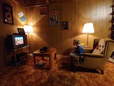 a man sitting in a chair watching tv