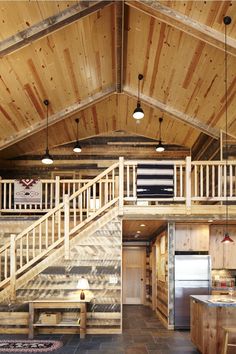 the inside of a log cabin with stairs