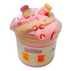 a cupcake shaped toy sitting on top of a plastic container filled with frosting