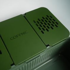 two green laptops sitting side by side on top of each other with the words cofinic written on them