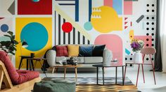 a living room filled with furniture and colorful wall art on the walls above them is a coffee table