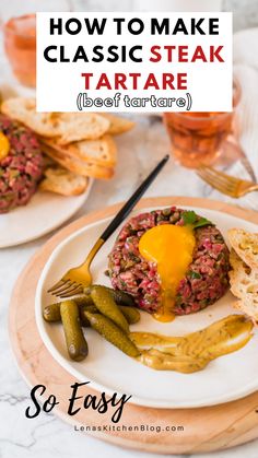 a white plate topped with meat covered in sauce and green beans next to some bread