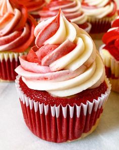 cupcakes with red and white frosting on them