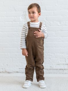 Welcome the season with the Remi Corduroy Overall, designed for both style and functionality. Featuring adjustable button straps for a customizable fit, this overall includes front and back patch pockets for handy storage. The side buttons make it easy to slip on and off, while the snap leg opening and crotch gusset ensure quick and convenient diaper changes. The soft corduroy fabric adds warmth and durability, making it perfect for fall and winter adventures. The Remi Corduroy Overall combines Brown Cotton Overalls For Spring, Brown Cotton Overalls With Pockets, Brown Cotton Overalls, Cotton Bib Front Overalls With Button Closure, Everyday Cotton Overalls With Side Pockets, Cotton Overalls With Button Closure, Utility Cotton Overalls With Buttons, Cotton Overalls For Everyday Fall Wear, Fall Cotton Overalls With Adjustable Straps