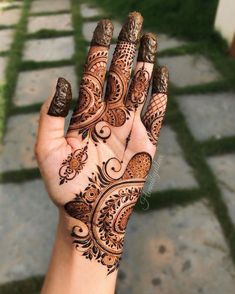 a woman's hand with henna tattoos on it