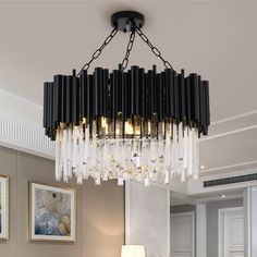 a chandelier hanging from the ceiling in a living room