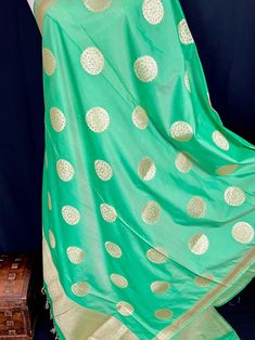 Beautiful Green Color Handmade Dupatta with Chakra design and floral design on the borders. Super Light weight and very easy to carry. Can be worn with a Suit or lehenga easily. Item: DupattaBase color : Light Green Color Zari Work : Gold Fabric : Premium quality Banarasi Soft Silk (Non-Pure)Work : Zari Weaved with tasselsLength of the dupatta : 92 inches Width of the dupatta : 37 inches Store Policies - No return or exchange will be accepted for color variations. - No return or exchange will be Pista Green Bollywood Lehenga With Zari Weaving, Bollywood Style Pista Green Lehenga With Zari Weaving, Green Anarkali Set With Traditional Drape For Puja, Green Traditional Anarkali Set For Puja, Green Banarasi Silk Dupatta Chandbali, Pista Green Katan Silk Bollywood Lehenga, Green Sharara With Design For Puja, Pista Green Bollywood Lehenga In Katan Silk, Green Sharara With Self Design For Puja