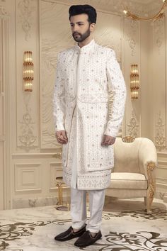 This groom's sherwani, U2-S336, features intricate thread and red accents, as well as sparkling stones. With this traditional and stylish design, the groom will make a statement on his special day. The perfect combination of cultural heritage and contemporary style, The overlapping layers create a unique texture. Mens Sherwani, Hrithik Roshan, Red Accents, The Groom, Cultural Heritage, Stylish Design, Special Day, Contemporary Style, Thread