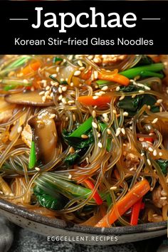 a plate full of noodles and vegetables with sesame seeds