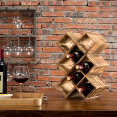 a wooden wine rack sitting on top of a table next to a bottle of wine