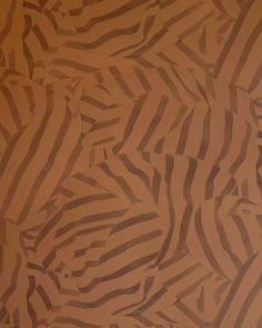 an animal print wallpaper with brown and black stripes on it's surface,