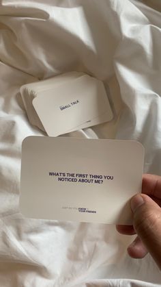 someone holding up a card that says what's the first thing you noticed about me?