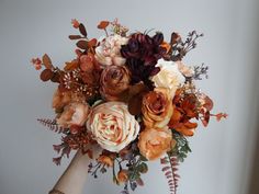 a woman holding a bouquet of flowers in her hand