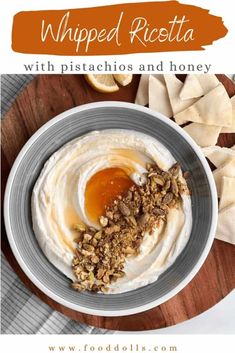 whipped ricotta with pistachios and honey in a bowl on a wooden board