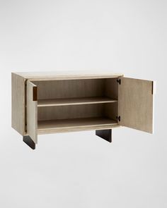 an open cabinet with two shelves on one side and the door closed to reveal something