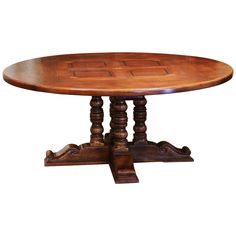 an oval wooden table with carved legs