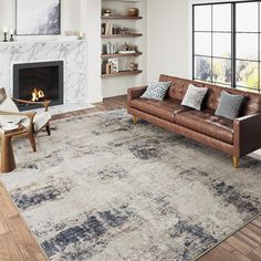 a living room with a couch, chair and fireplace