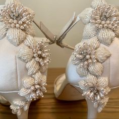 the shoes are decorated with flowers and pearls