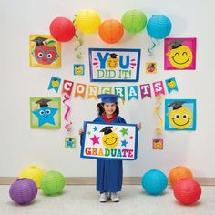 Make your graduation party space shine with these cheerful decorations! Featuring smiling apples, graduation caps, and other bright school icons, these colorful decorations are the perfect addition to your graduation party supplies. And best of all, with a variety of decorations to choose from, you can create the exact look you want for your elementary graduate's celebration. (31 pcs. per unit)Includes:o 12 Solid Color Paper Lanterns (12" Includes metal hanger. Simple assembly required.)o 1 Card Graduation Party For Preschoolers, Diy Preschool Graduation Decorations, Graduation Preschool Ideas Decorations, Kindergarden Graduation Decor, Graduation Backdrop Ideas Diy Preschool, Preschool Graduation Photo Booth, Graduation Kindergarten Ideas, Graduation Day Decoration For Kids