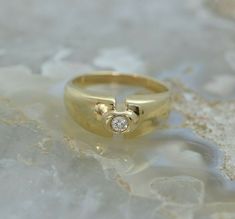 "14K Yellow Gold Tested Diamond Ring, approximately 20 pt. round center stone, HSI, bright polish, 5/16\" across, bezel set, Circa 1980, ring size 7.25, weight 4.4 grams Stock # BB115R06 This listing contains photographs of the actual item you will receive. Our items are in excellent condition with little or no signs of wear and many are one of a kind pre-owned estate finds. Please look closely at the pictures in this listing as they are part of the product description. Please read the descripti Yellow Gold Signet Ring With Round Stone For Anniversary, Gold Round Signet Ring With Tension Setting, Fine Jewelry Designers, Anniversary Bands, Blue Topaz Ring, Topaz Ring, Ring Size 7, Pink Tourmaline, Bezel Setting