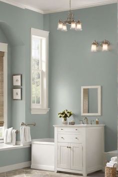 a bathroom with blue walls and white fixtures