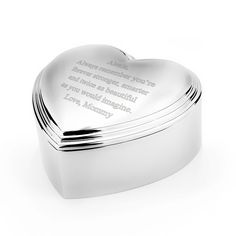 a silver heart shaped box with a poem on the front and inside, sitting on a white surface