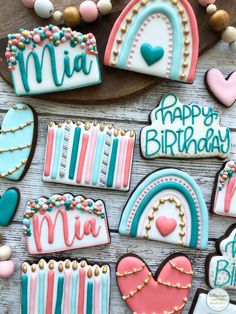 decorated cookies are arranged on a wooden table