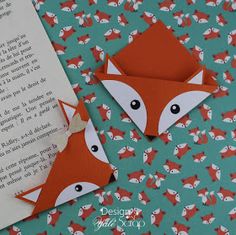 an open book with two folded foxes on it