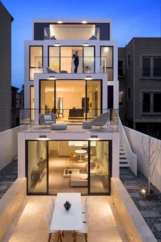 a modern house with an outdoor dining area