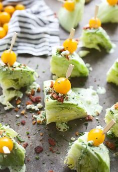 small appetizers are arranged on a tray with toothpicks