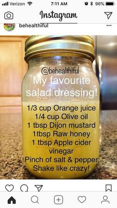 a jar filled with orange juice sitting on top of a counter