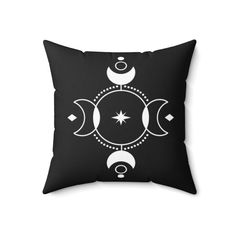 a black and white pillow with three crescents on the front, two stars in the middle