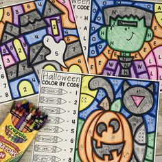 halloween coloring pages with markers and crayons on the table next to each other