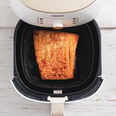 an air fryer with some food inside of it