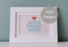 a cross stitch pattern with the words home sweet home and a red heart on it