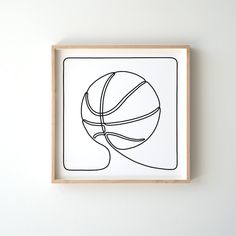 a black and white drawing of a basketball ball on a wooden framed wall art piece