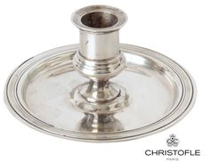 a silver plate with a candle holder on it