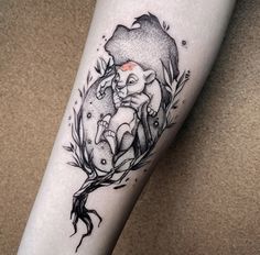 a tattoo on the leg of a woman with an elephant and tree branch in it